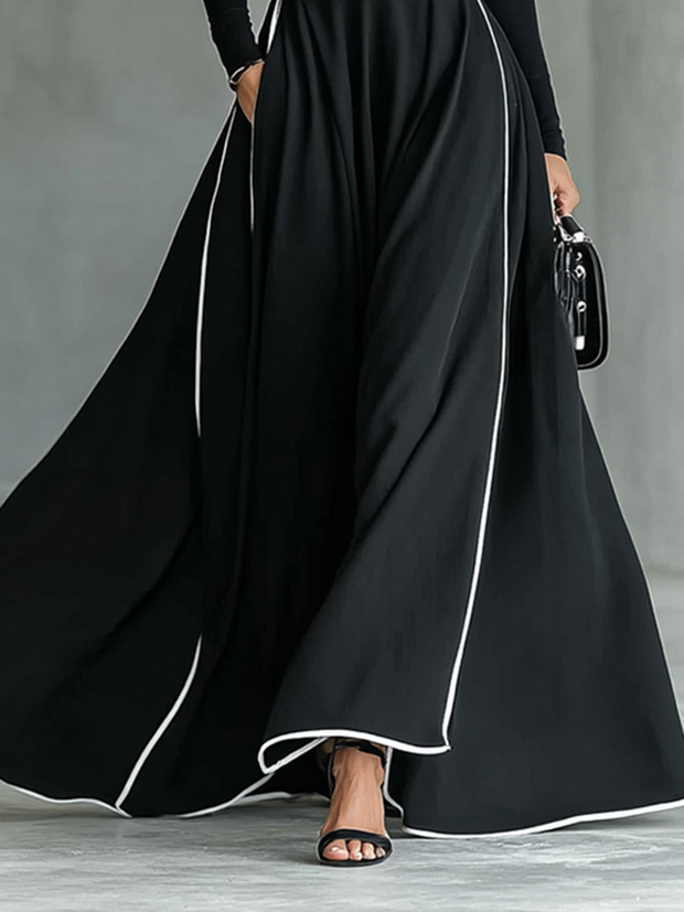 Maxikleid mit hohem Kragen, langen Ärmeln, schwarzer Naht, weißem Besatz und engem Gürtel